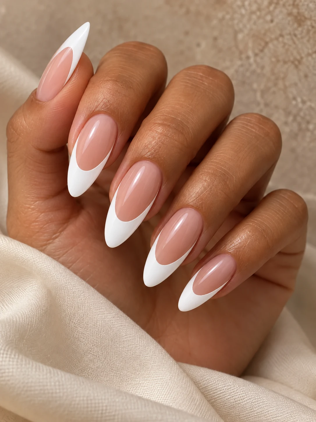 Deep French: long almond nails with glossy white French tips and nude-pink centers
