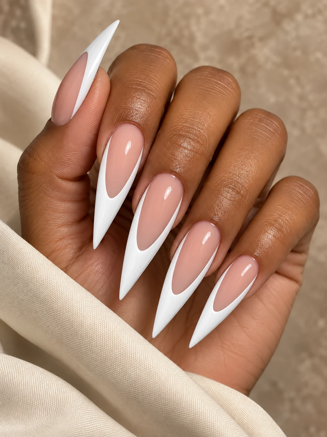 Extra Deep: extra-long stiletto nails with glossy white French tips and nude-pink centers
